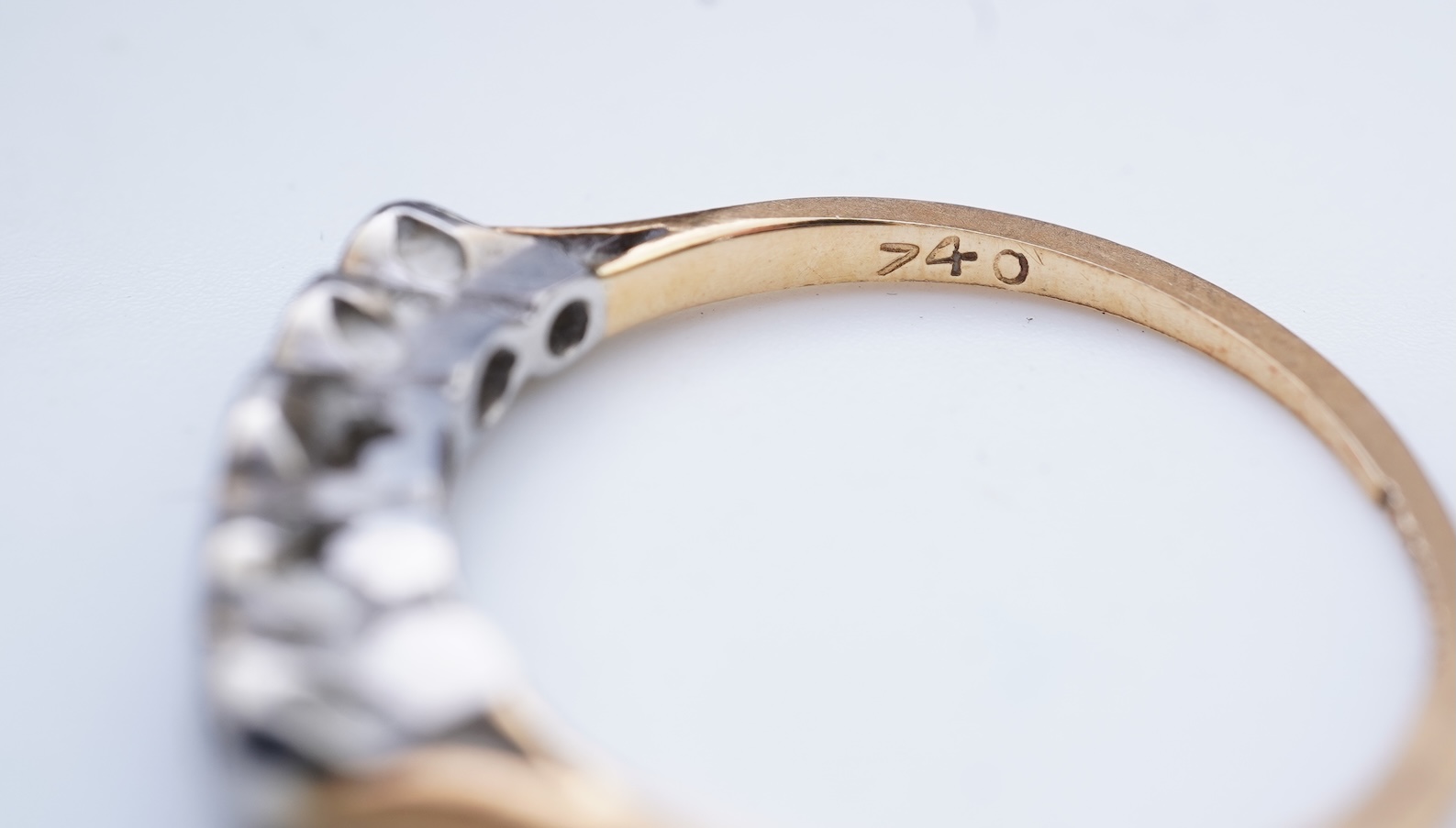 A collection of four rings and a pendant